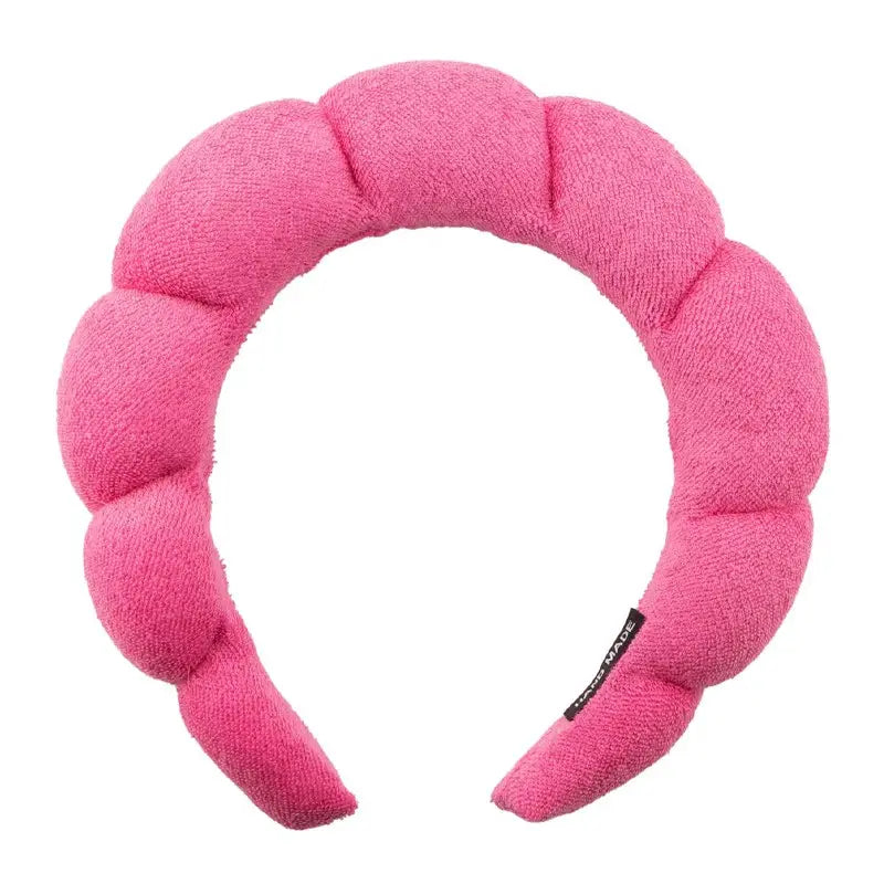 Hot pink padded spa headband with segmented plush sections