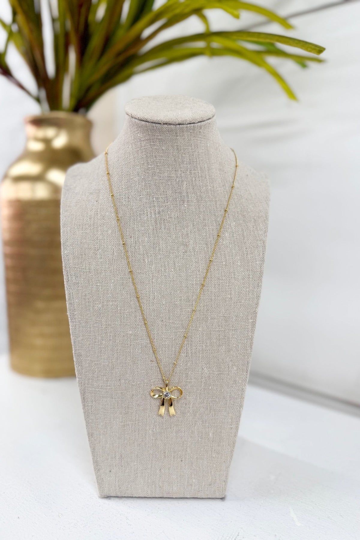 Necklace with a pave stone bow pendant