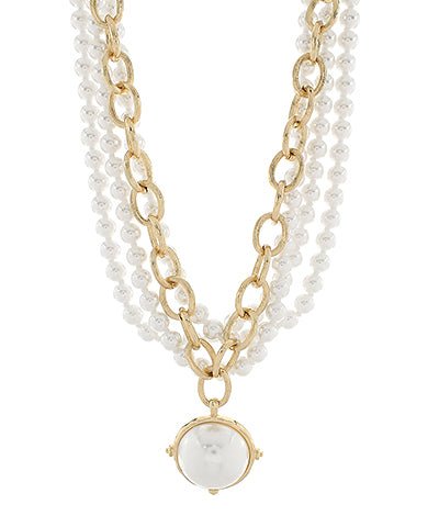 Layered gold necklace with dome-shaped cream pearls