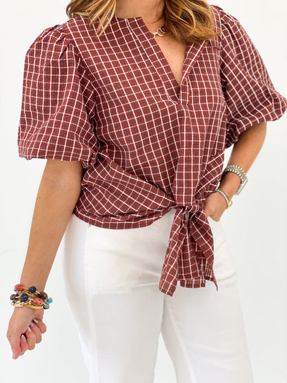 Red top with a knotted tie at the front