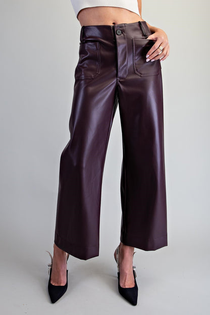 Black pleather pants with roomy patch pockets and a smooth finish