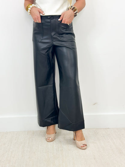 Black faux leather pants with large patch pockets