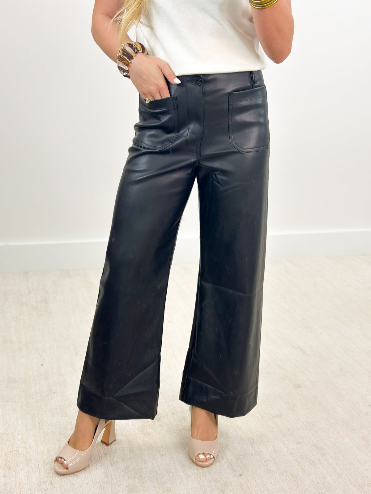 Black pleather pants with square patch pockets at the front