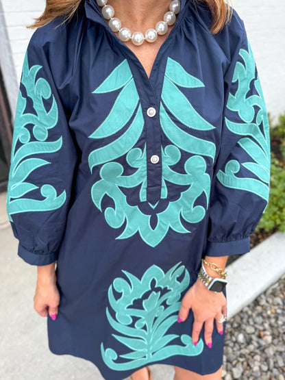 Embroidery detail on a long sleeve V-neck dress