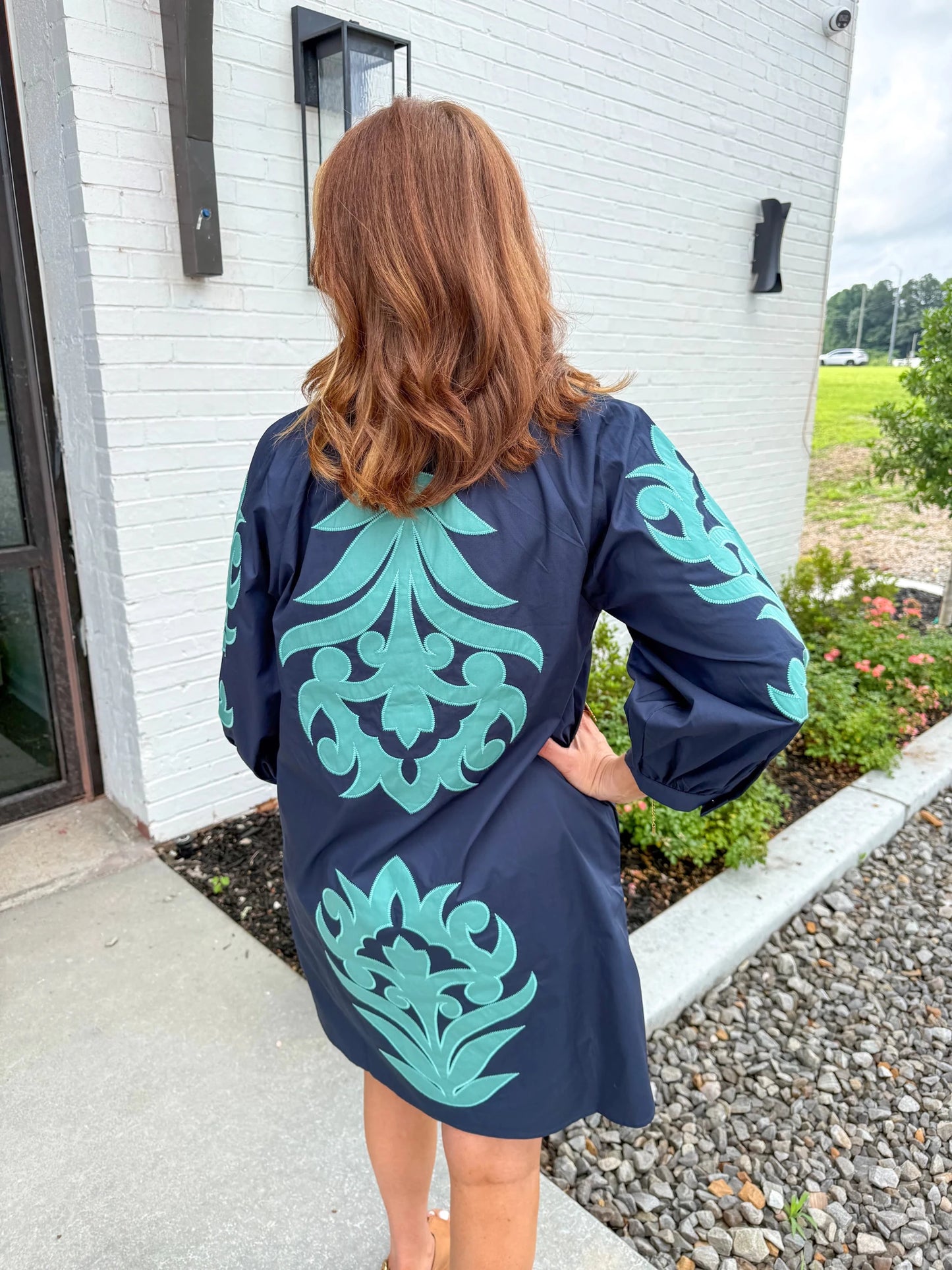 V-neck dress with embroidered floral motifs