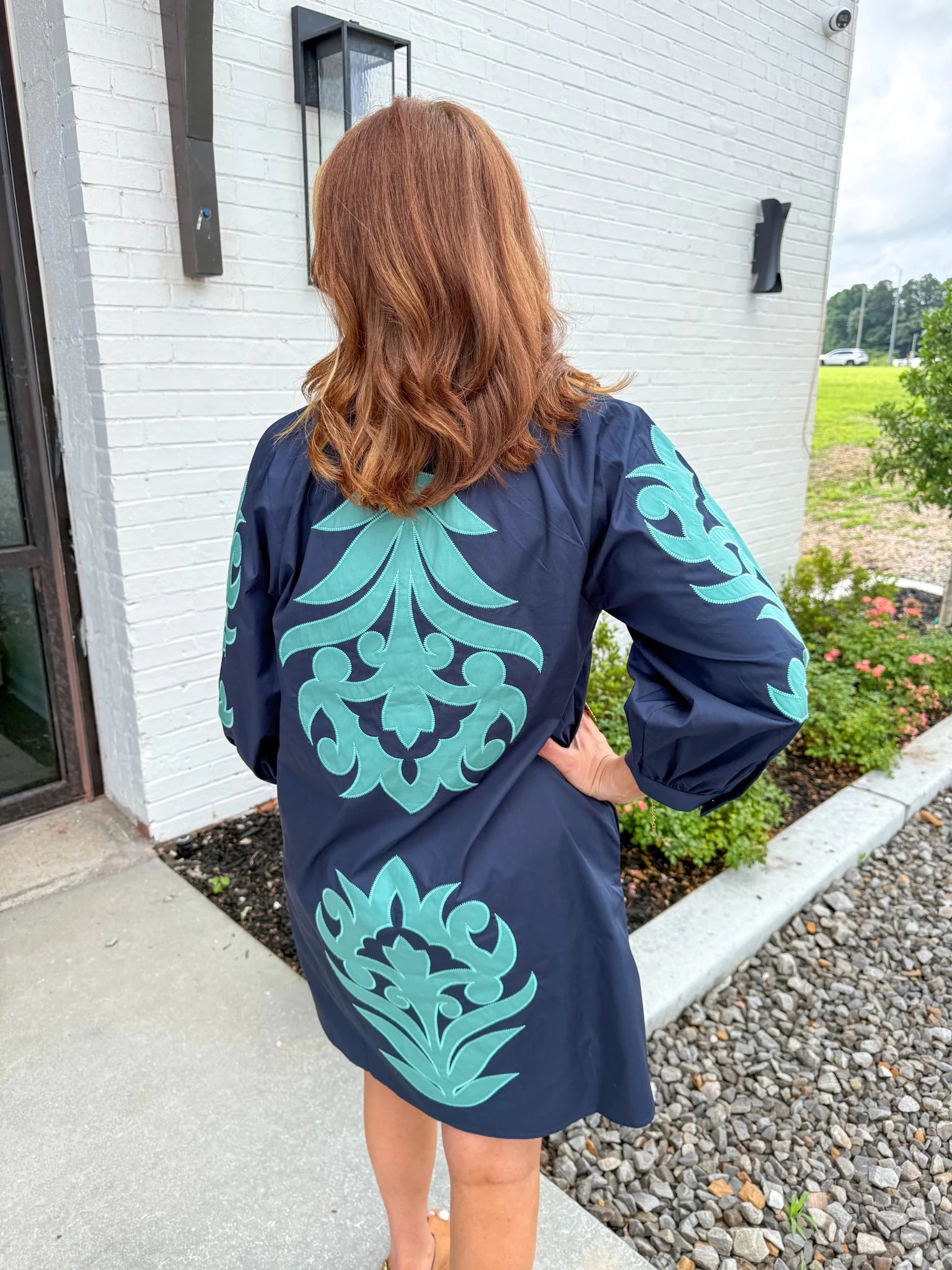 V-neck dress with embroidered floral motifs