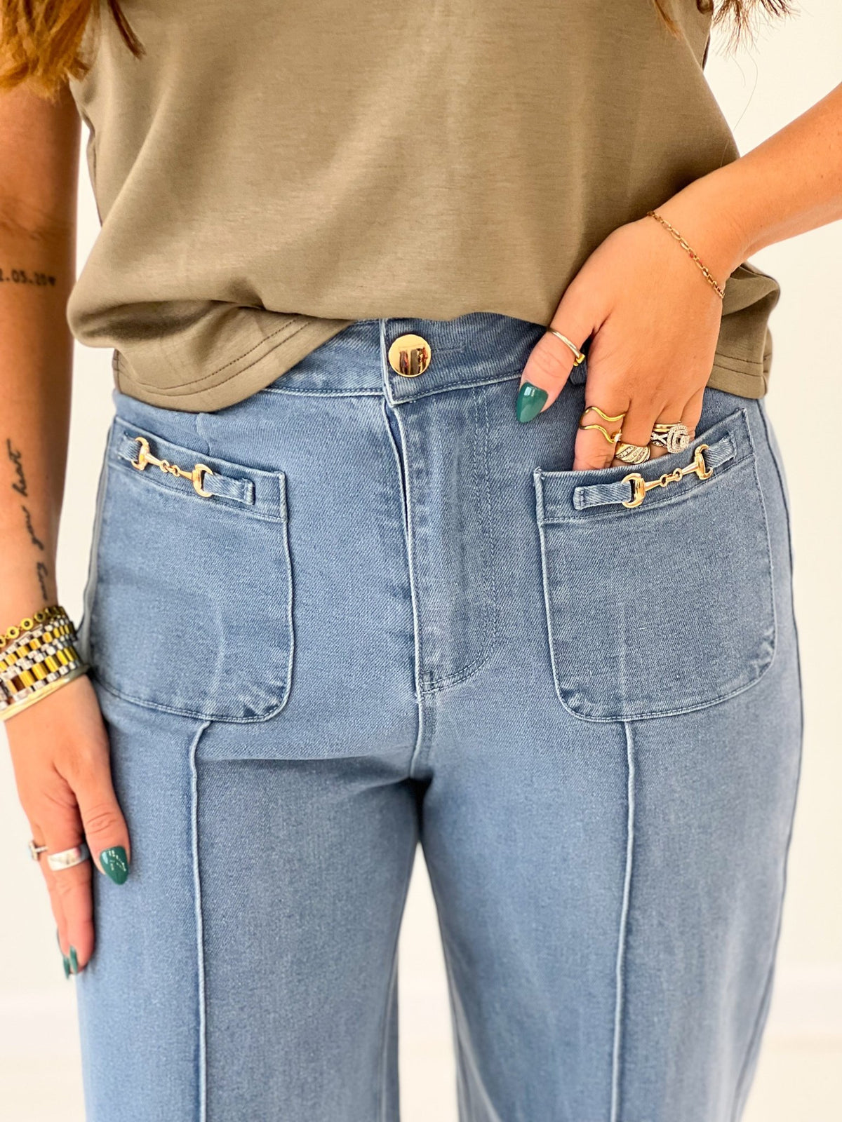 Wide leg pants with a horsebit style hardware trim