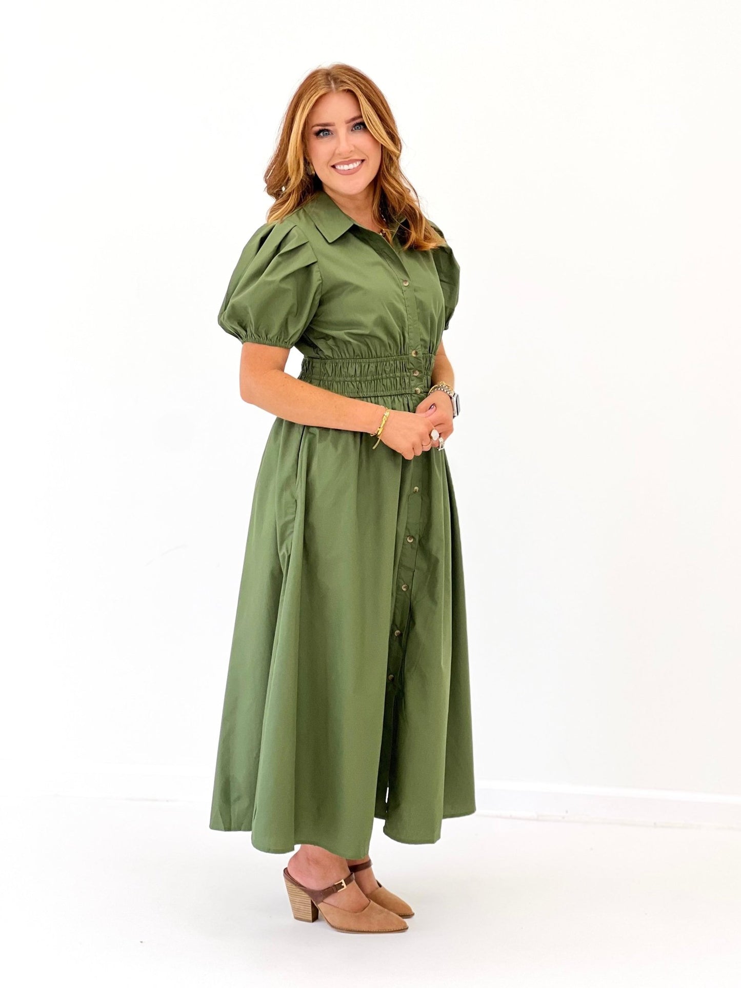 Puff sleeve detail on an olive button down dress
