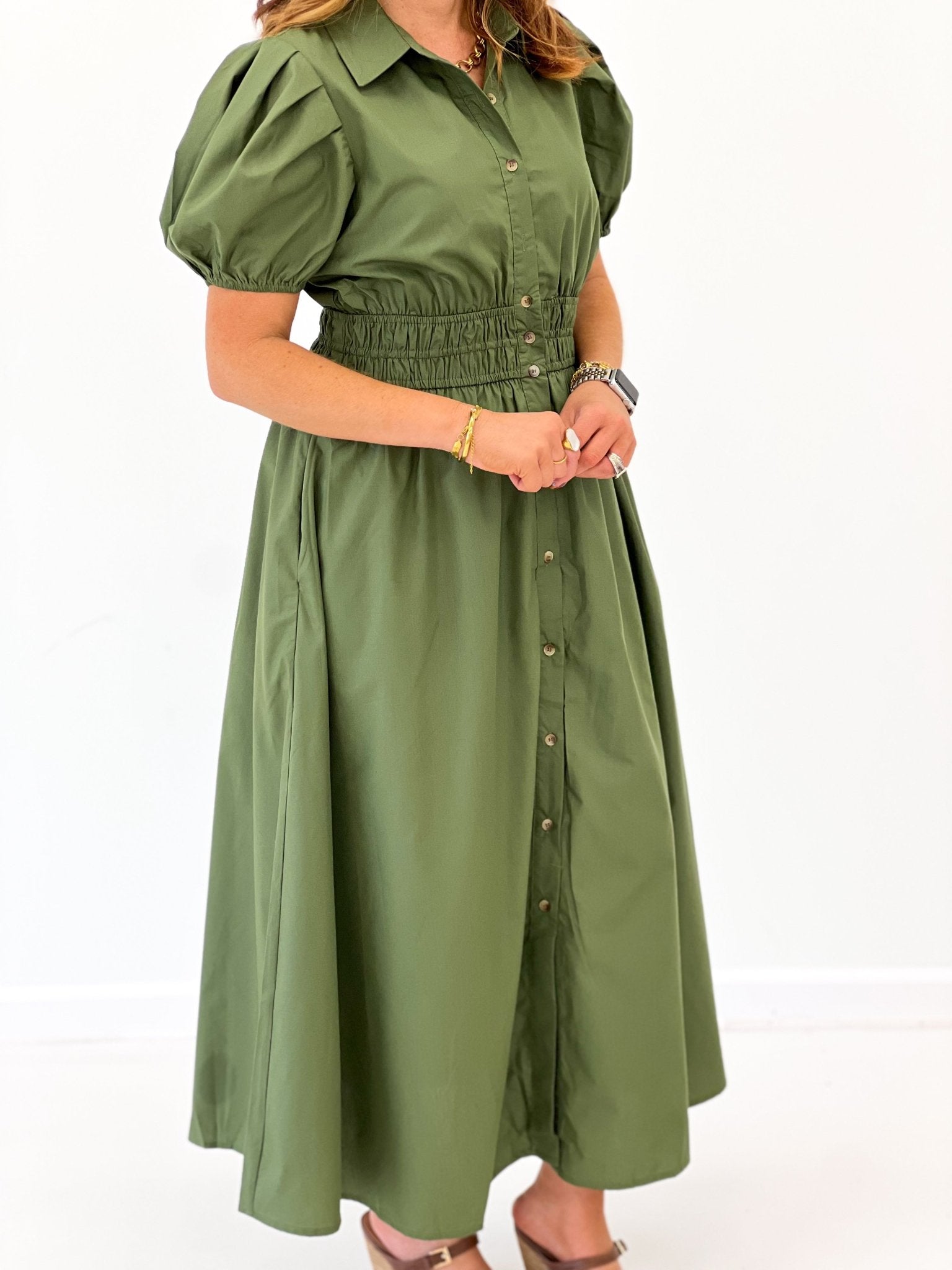 Button placket on an olive puff sleeve dress
