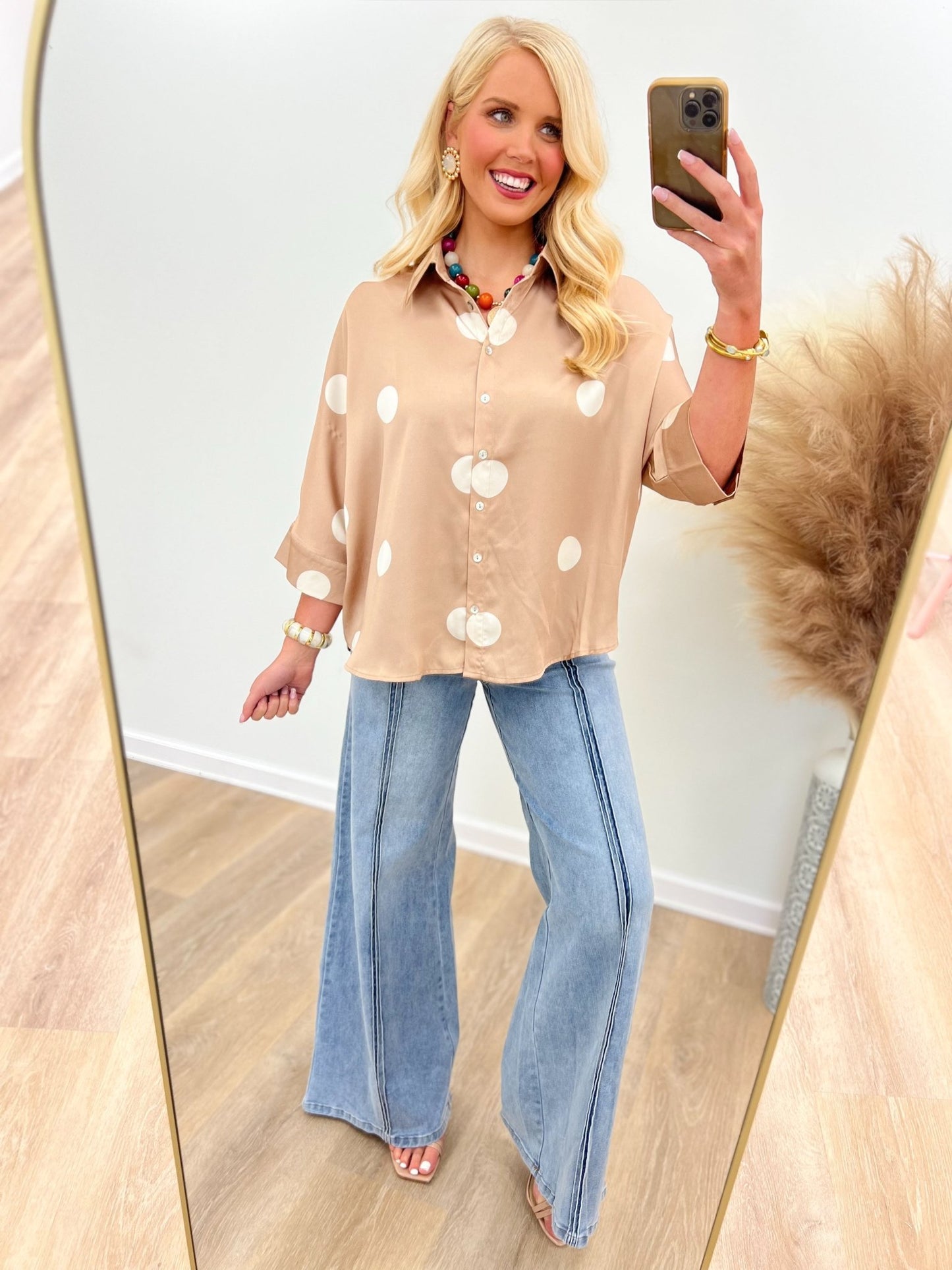 Latte polka dot button-up blouse with white dots, front buttons, and short sleeves.