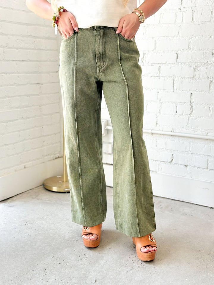 Olive denim pants with a front seam down each leg