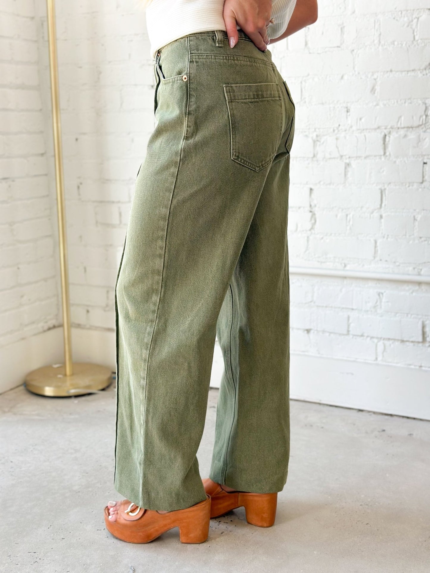 Olive denim pants with a centre front seam and straight leg