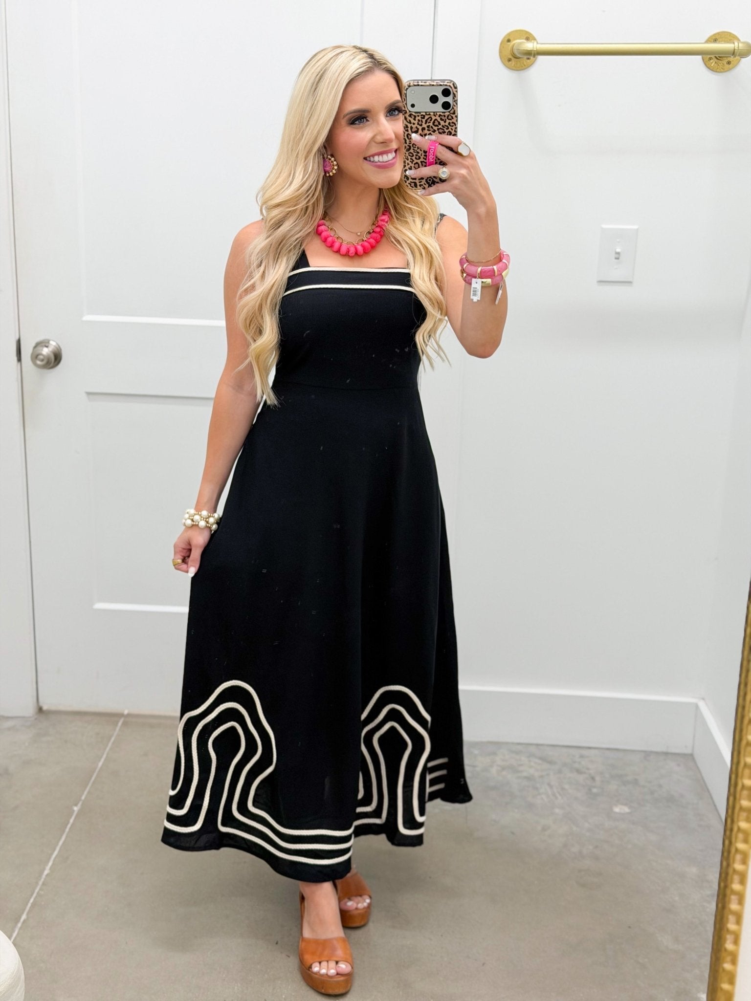 Embroidery detail on a black sleeveless dress