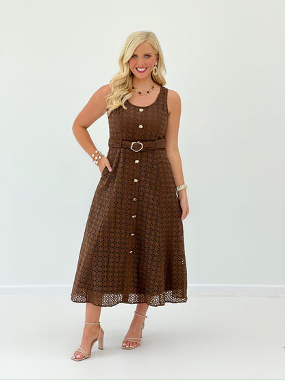 Button detail on a brown eyelet midi dress