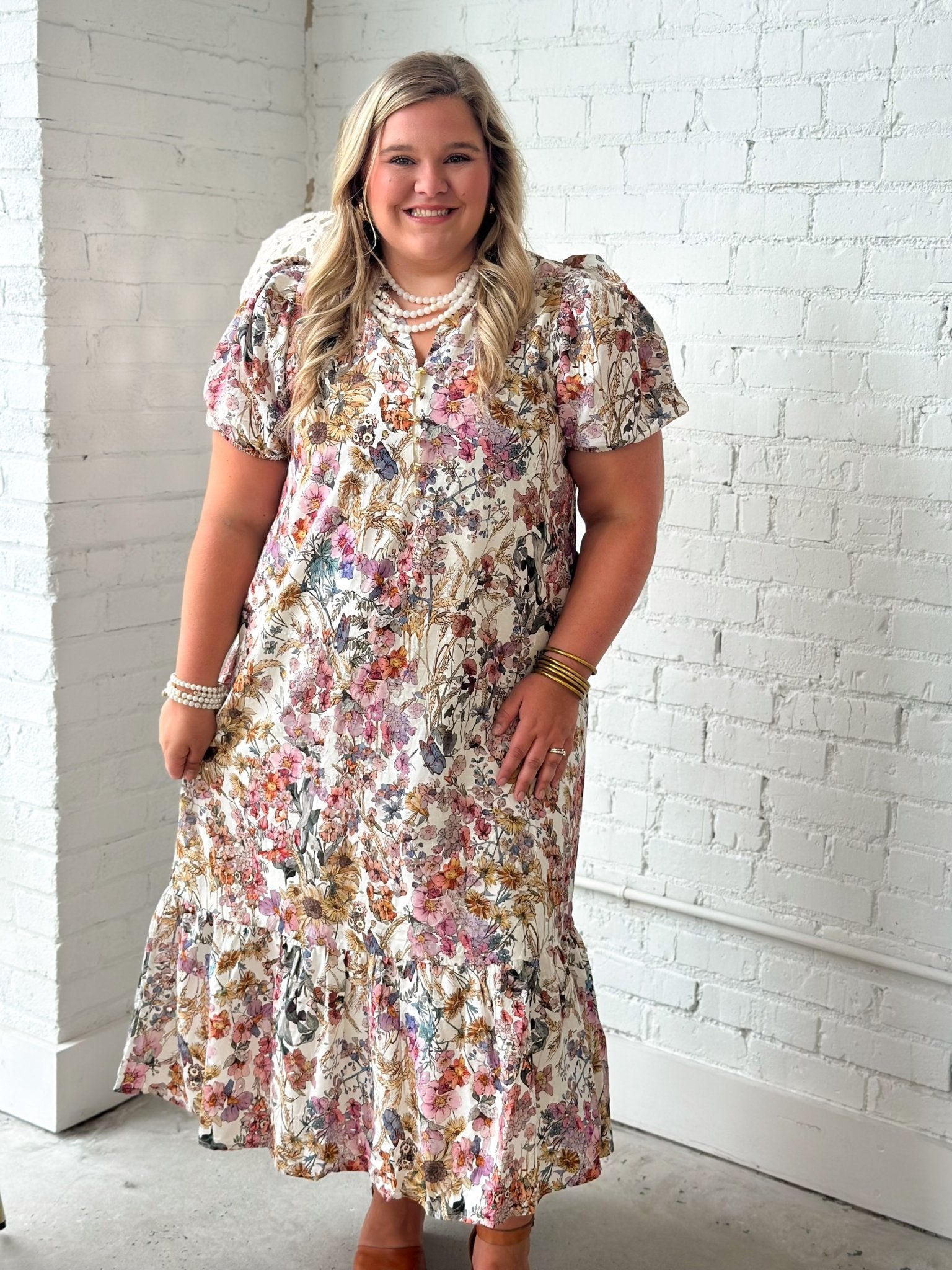 Ruffle collar and gold button detail on a floral eyelet midi dress