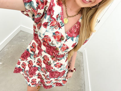 Ecru mini dress with a short hemline and floral print