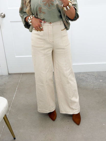 Ecru straight leg pants with scalloped pockets