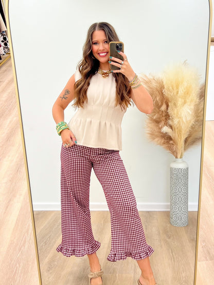 Sleeveless top with a defined pleated waistline