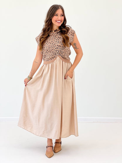 Camel sweater top layered over a cotton dress