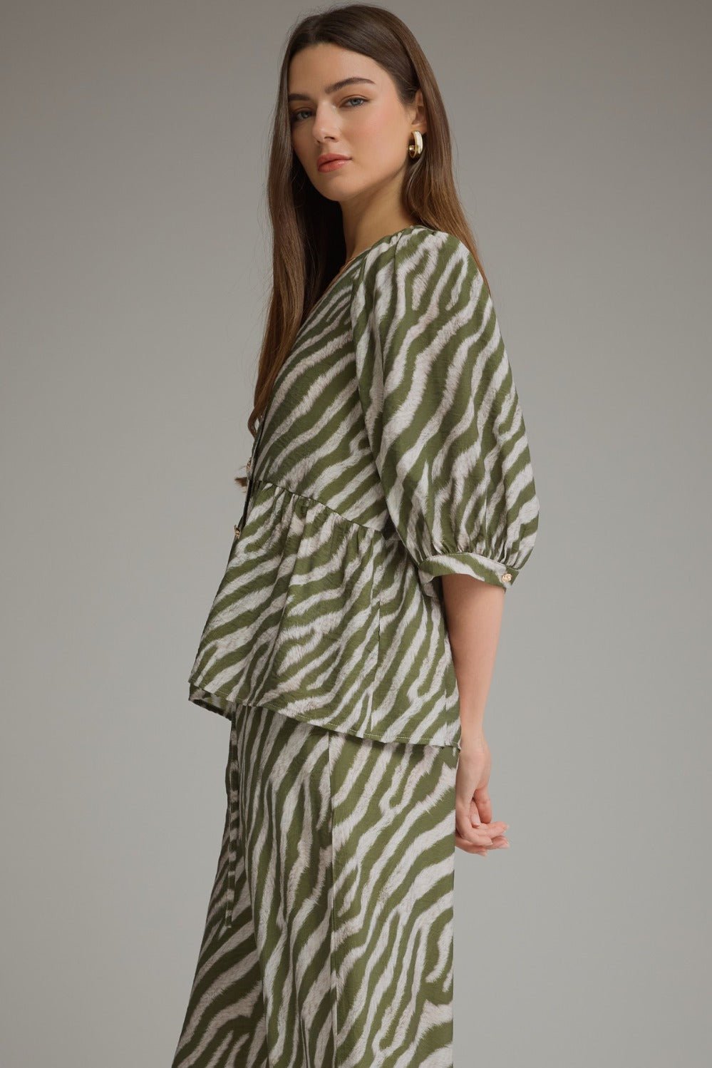 Olive top with gathered puff sleeves and a zebra stripe print