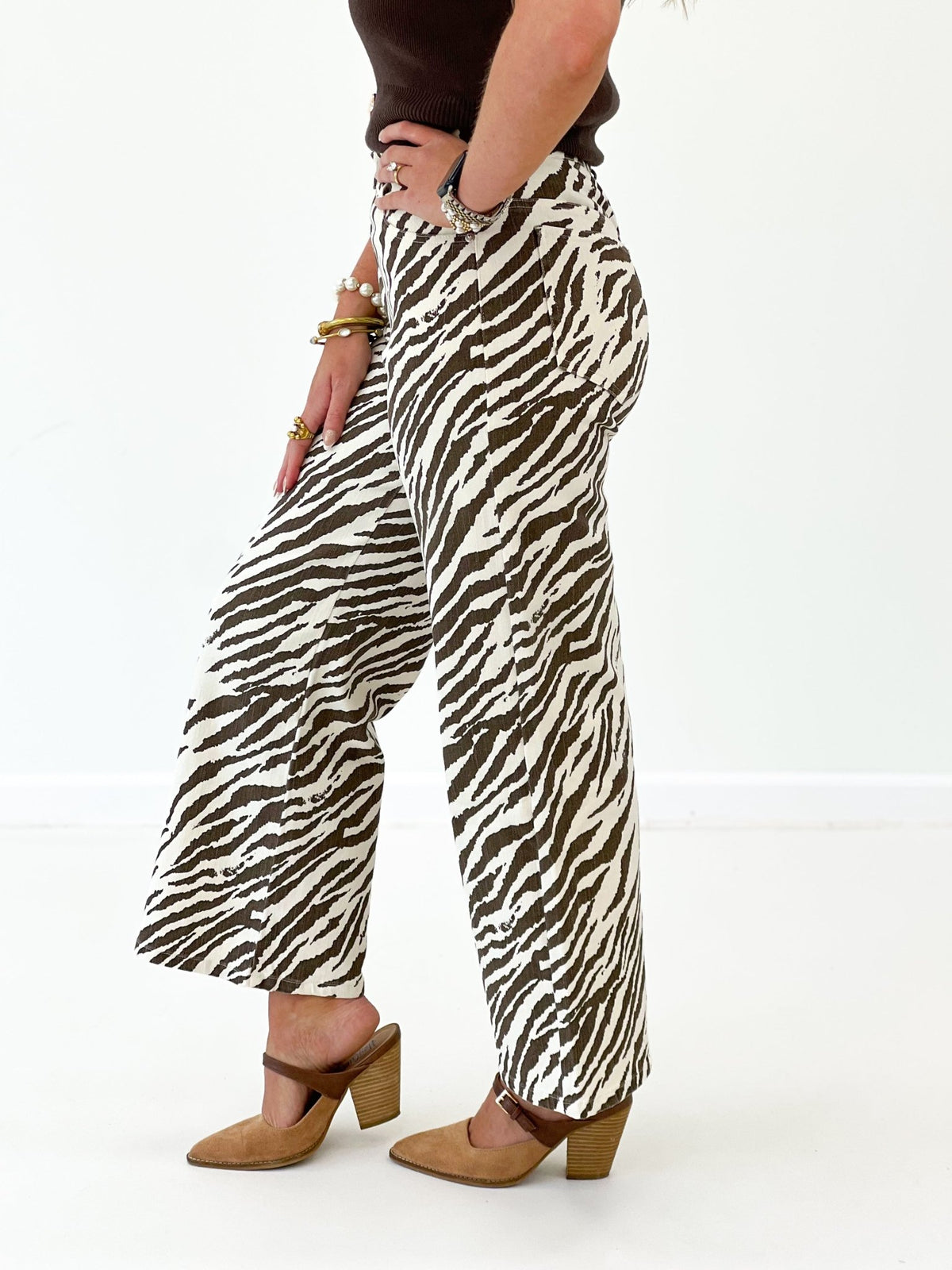 Ecru zebra-print wide-leg pants with black stripes, ankle-length relaxed fit.