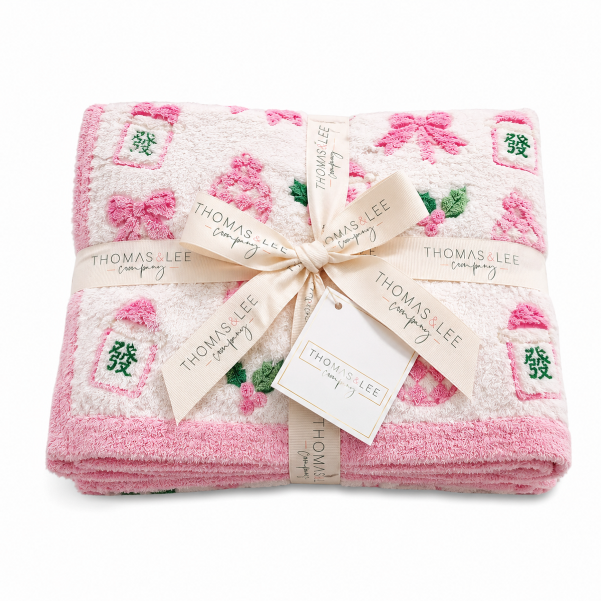 Thomas and Lee soft blanket in pink and white with candy, bows, and tree icons.
