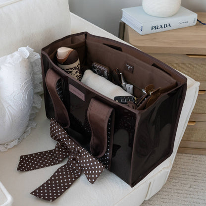 Espresso tote organizer holding bottles, phone, and stationery in compartment pockets