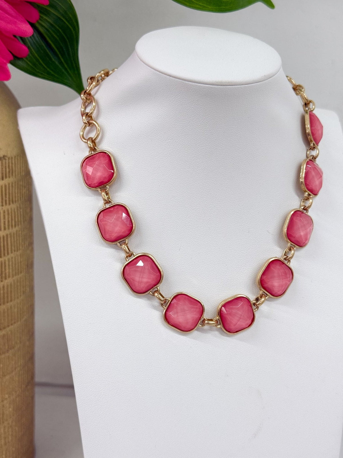 Faceted stone link necklace on a gold chain