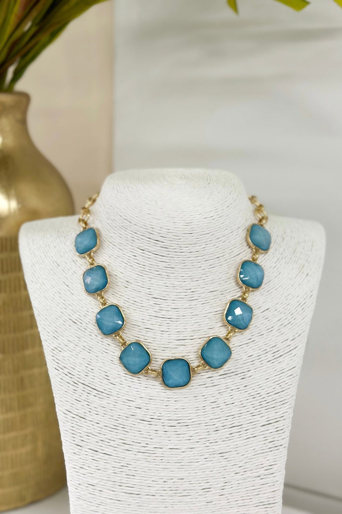 Necklace set with faceted stones linked in a row