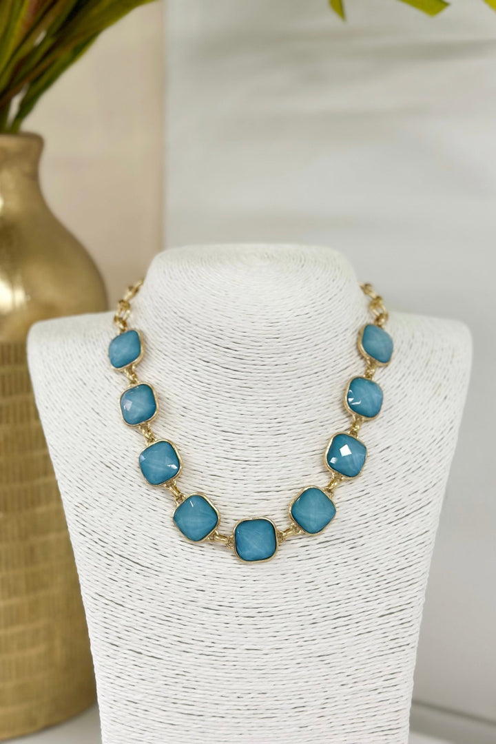 Necklace set with faceted stones linked in a row
