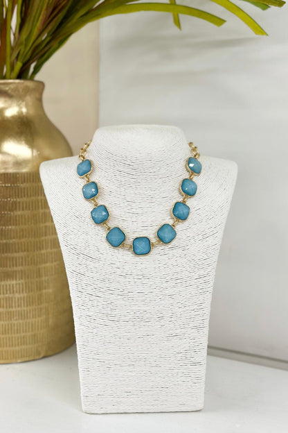 Faceted stones set in gold-tone links on a necklace