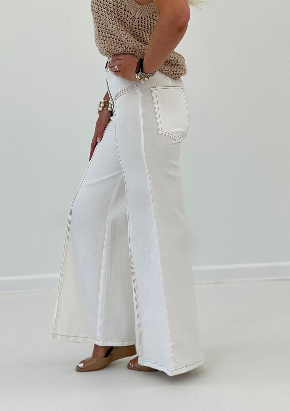 Cream flared pants with dark contrast stitch detail