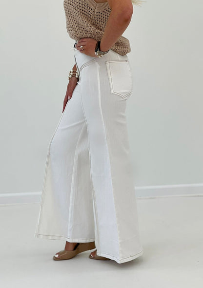 Cream flared pants with dark contrast stitch detail