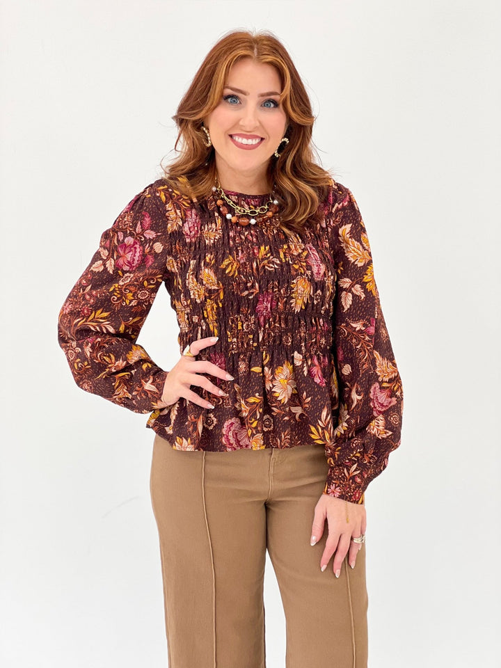 Dark brown floral top with a smocked bodice