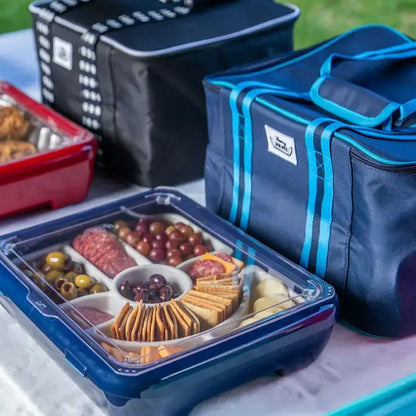 Blue insulated travel bag open, showing insulated compartments with food containers.