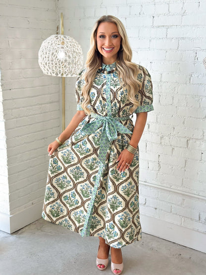 Natural floral print dress with a button up front and tie waist