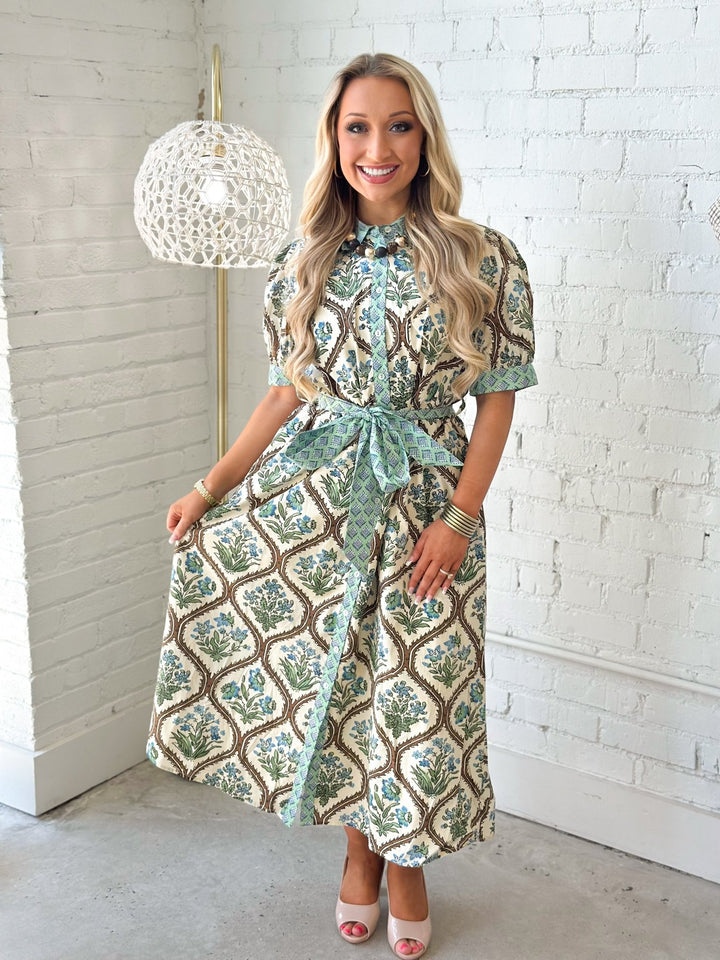 Natural floral print dress with a button up front and tie waist