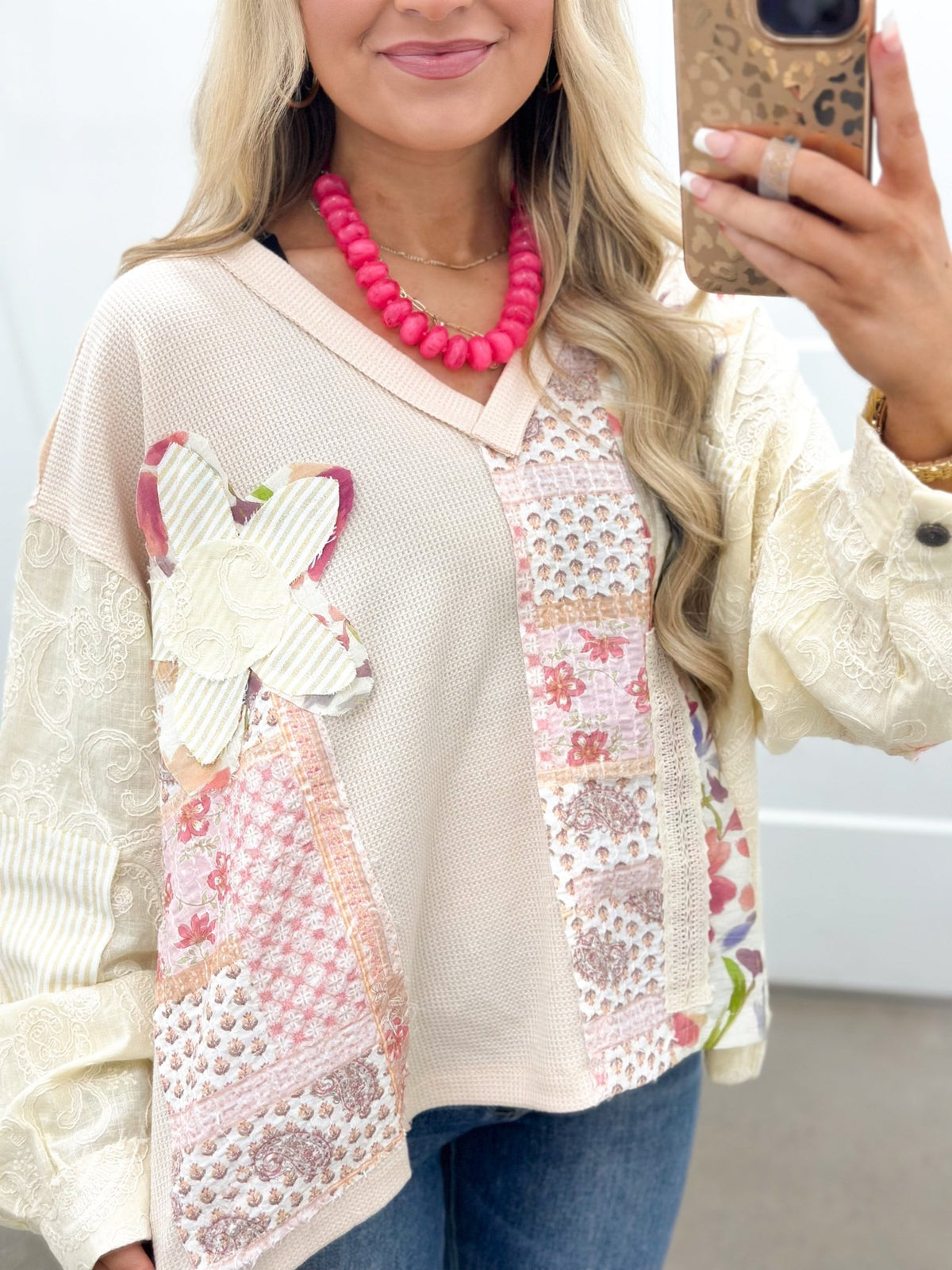 Long sleeve v-neck top with stitched floral patches
