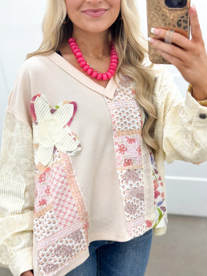 Long sleeve v-neck top with stitched floral patches