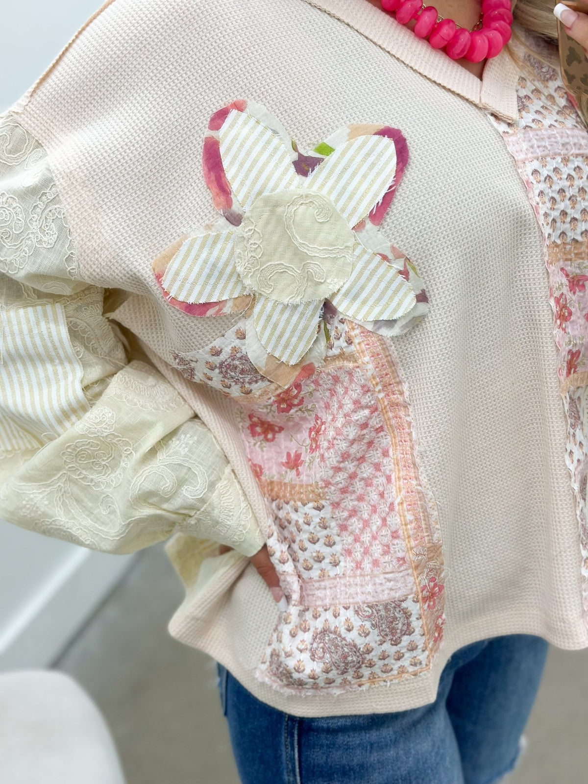 Floral patch top in a soft almond shade