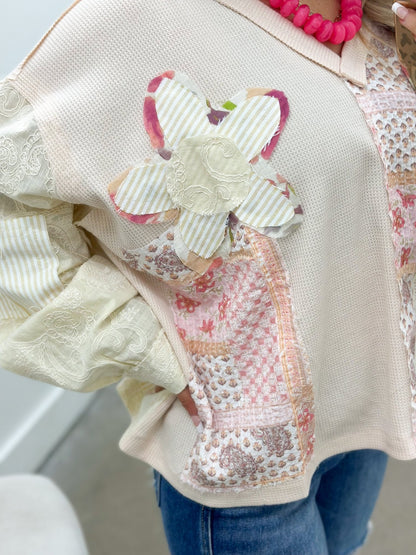 Floral patch top in a soft almond shade