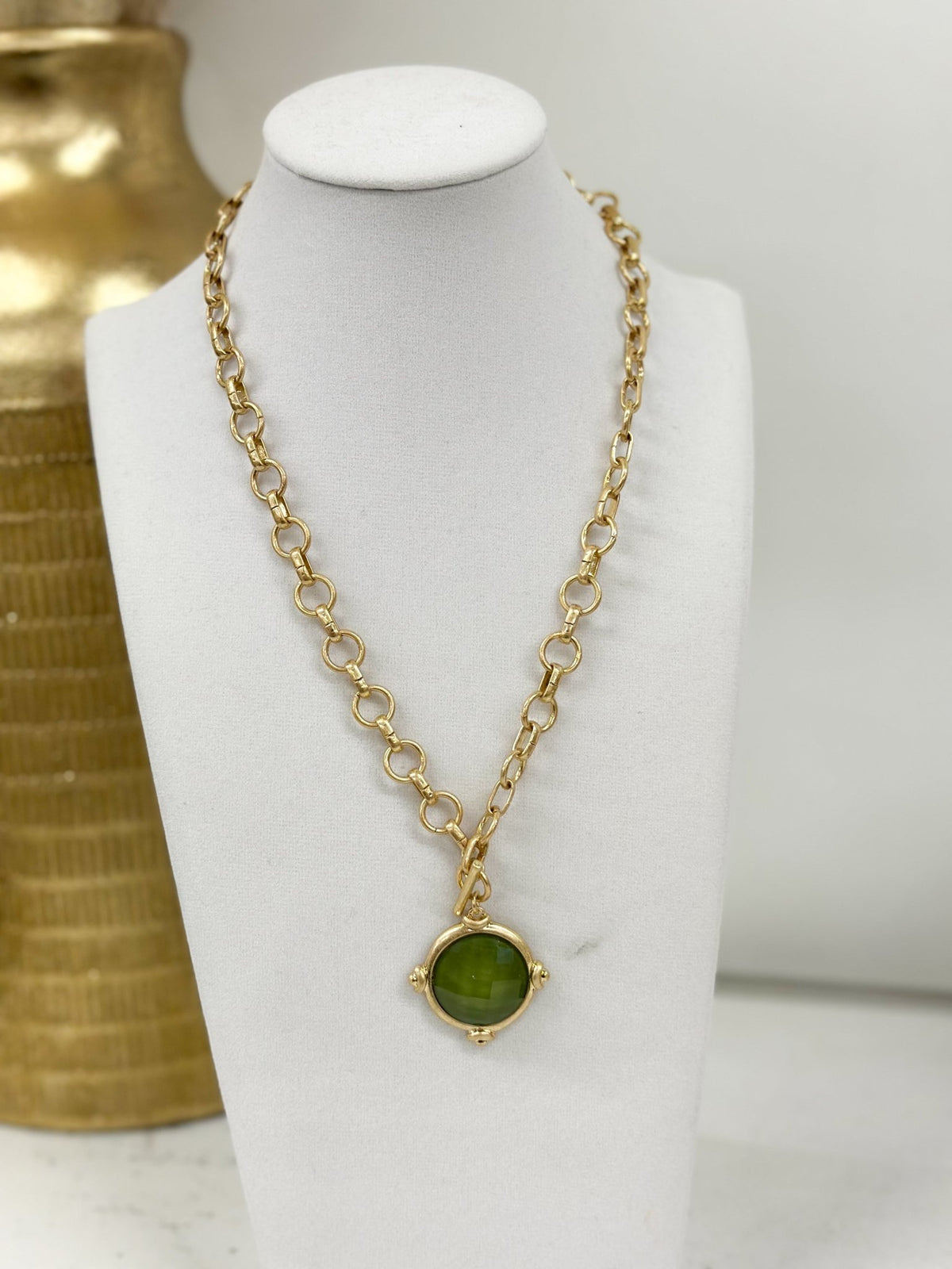 Framed stone pendants along a chain necklace
