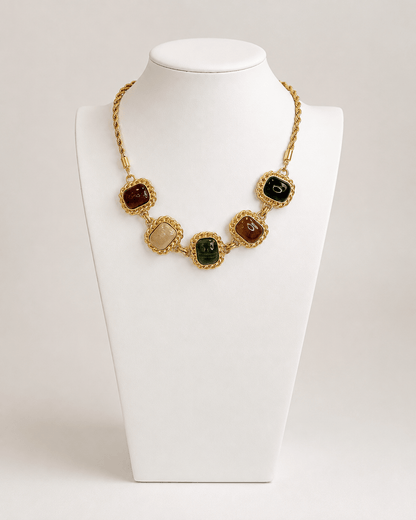 Framed stone necklace with stones set in gold-tone metal surrounds