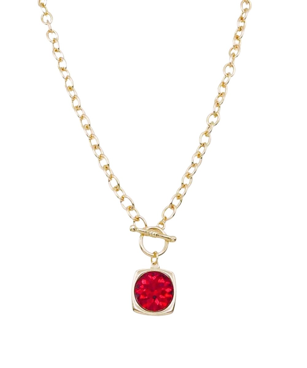 Chain necklace with a metal-framed faceted stone pendant