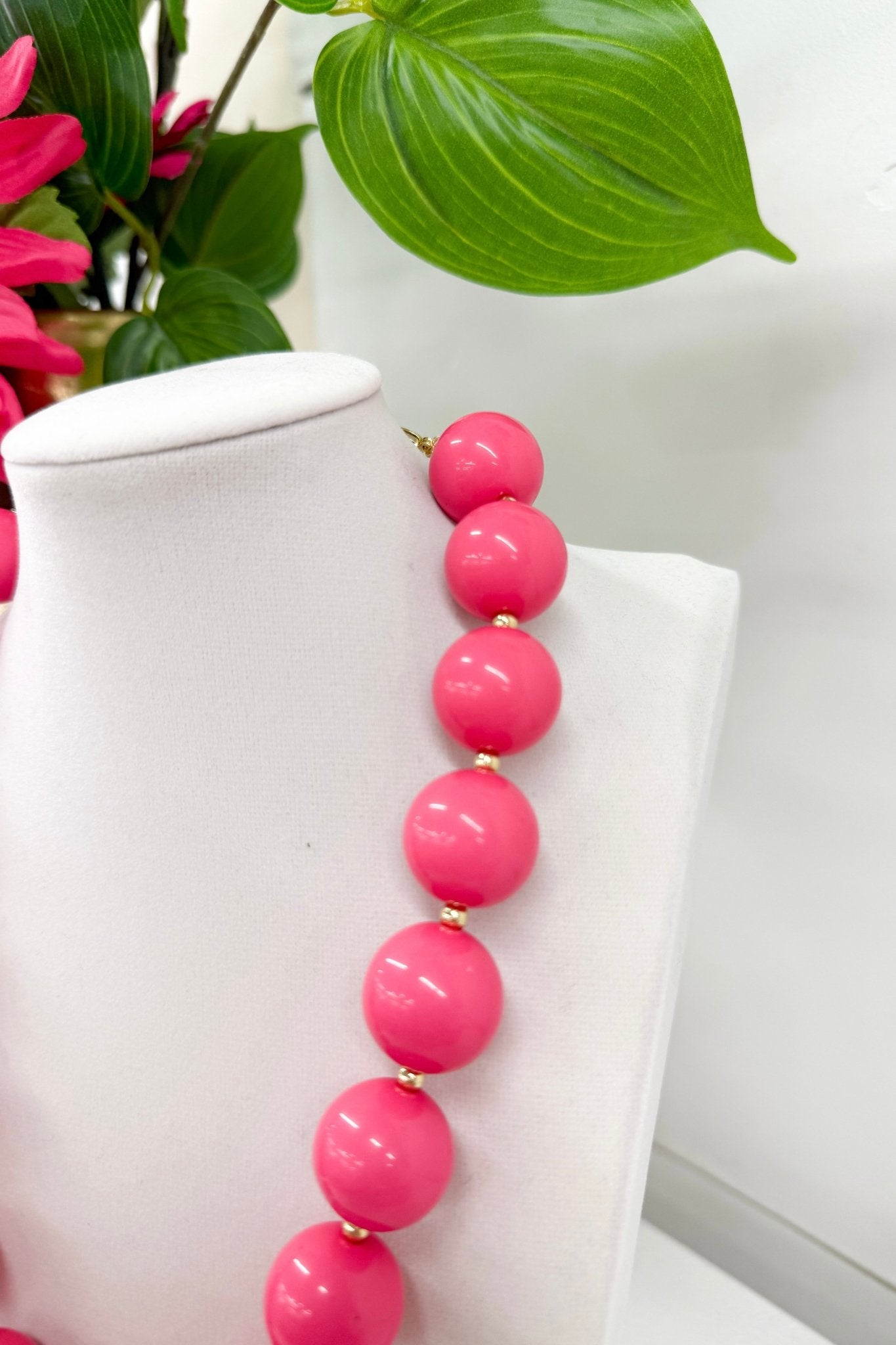 Glossy acrylic balls alternating with gold chain
