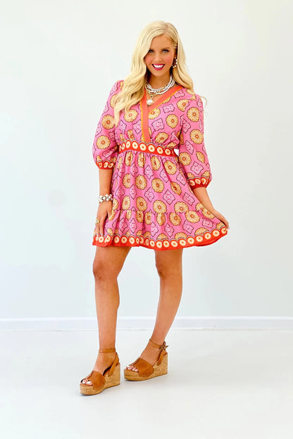 Gathered sleeves on a pink printed mini dress
