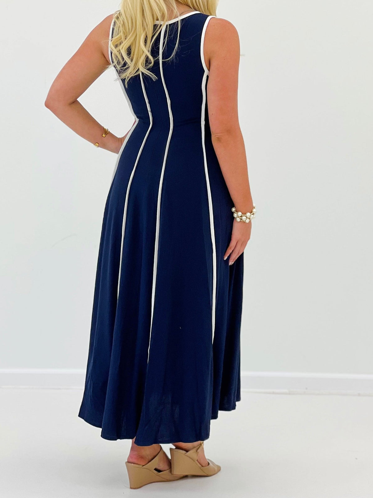 Navy sleeveless dress falling to midi length