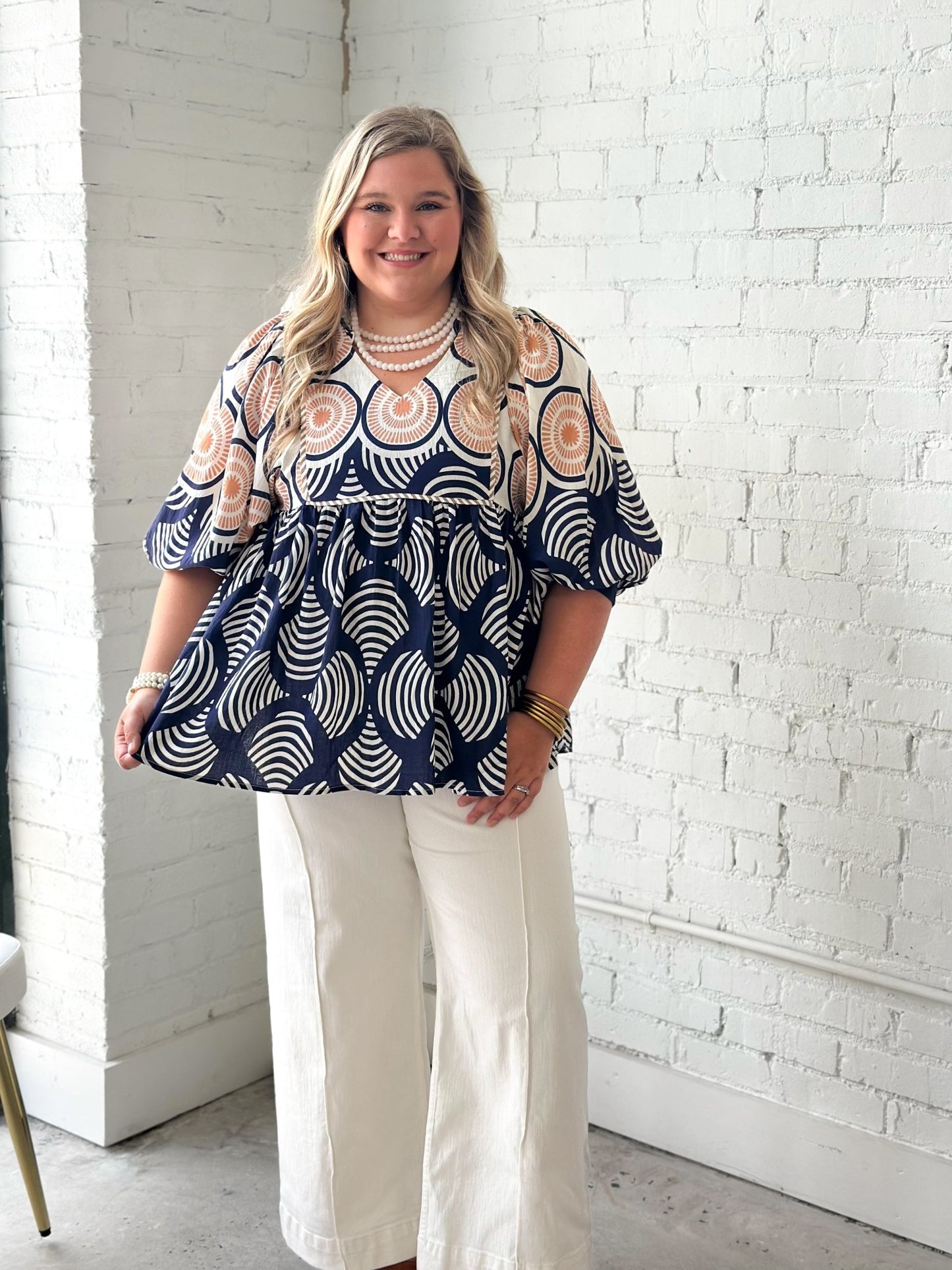 Printed babydoll top with a flared body and neck ruffle