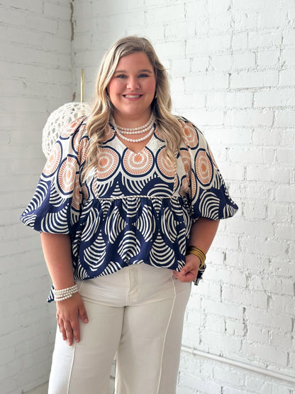 Ruffle neck babydoll blouse in a navy print