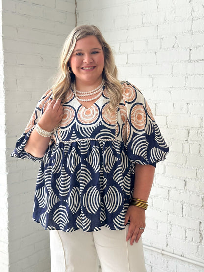 Navy printed babydoll top with a ruffled neckline